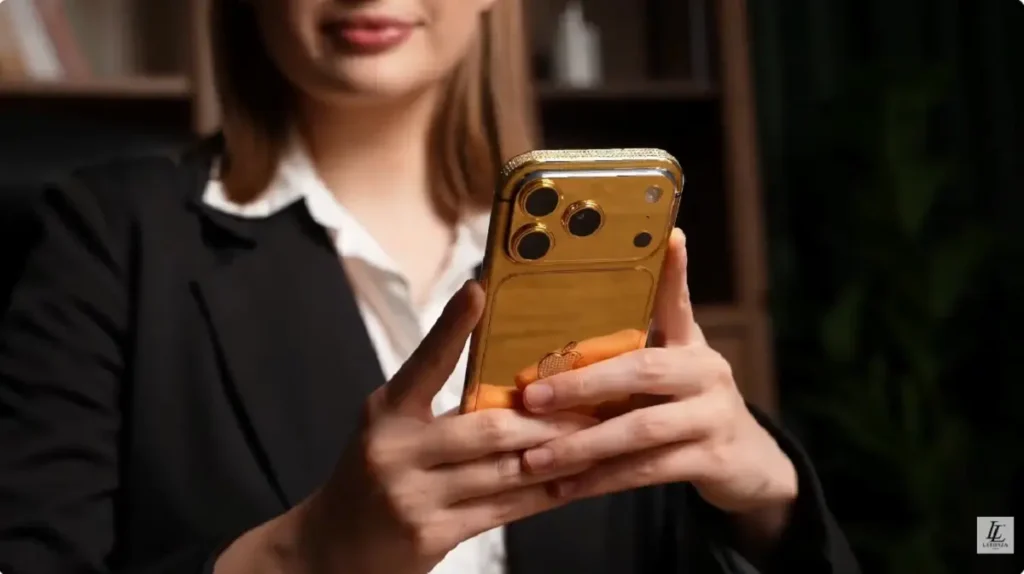 Customer unboxing a LERONZA™ Gold iPhone 17 from the Signature Collection.