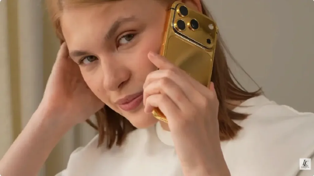 Business executive holding a LERONZA™ Gold iPhone from the Signature Collection.