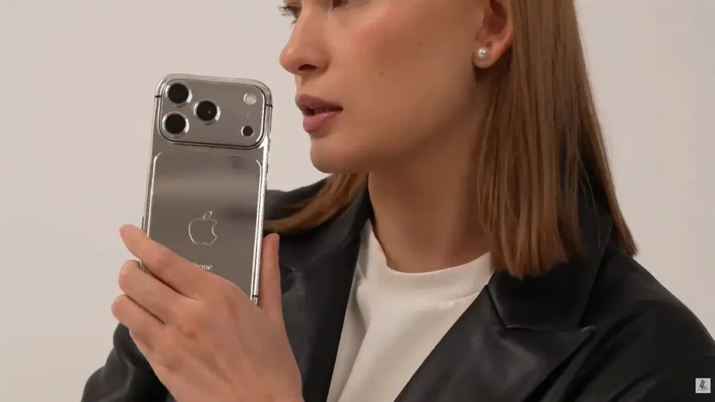Entrepreneur holding a LERONZA™ Gold iPhone from the Signature Collection.